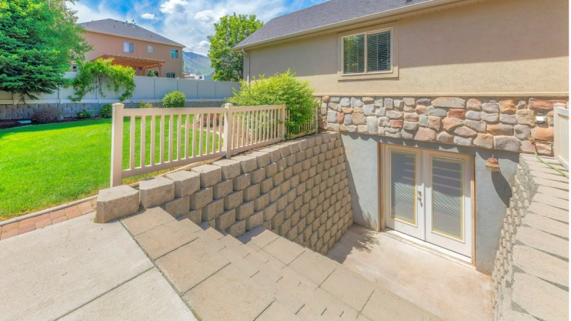 The exterior entrance to a basement leading out to a backyard